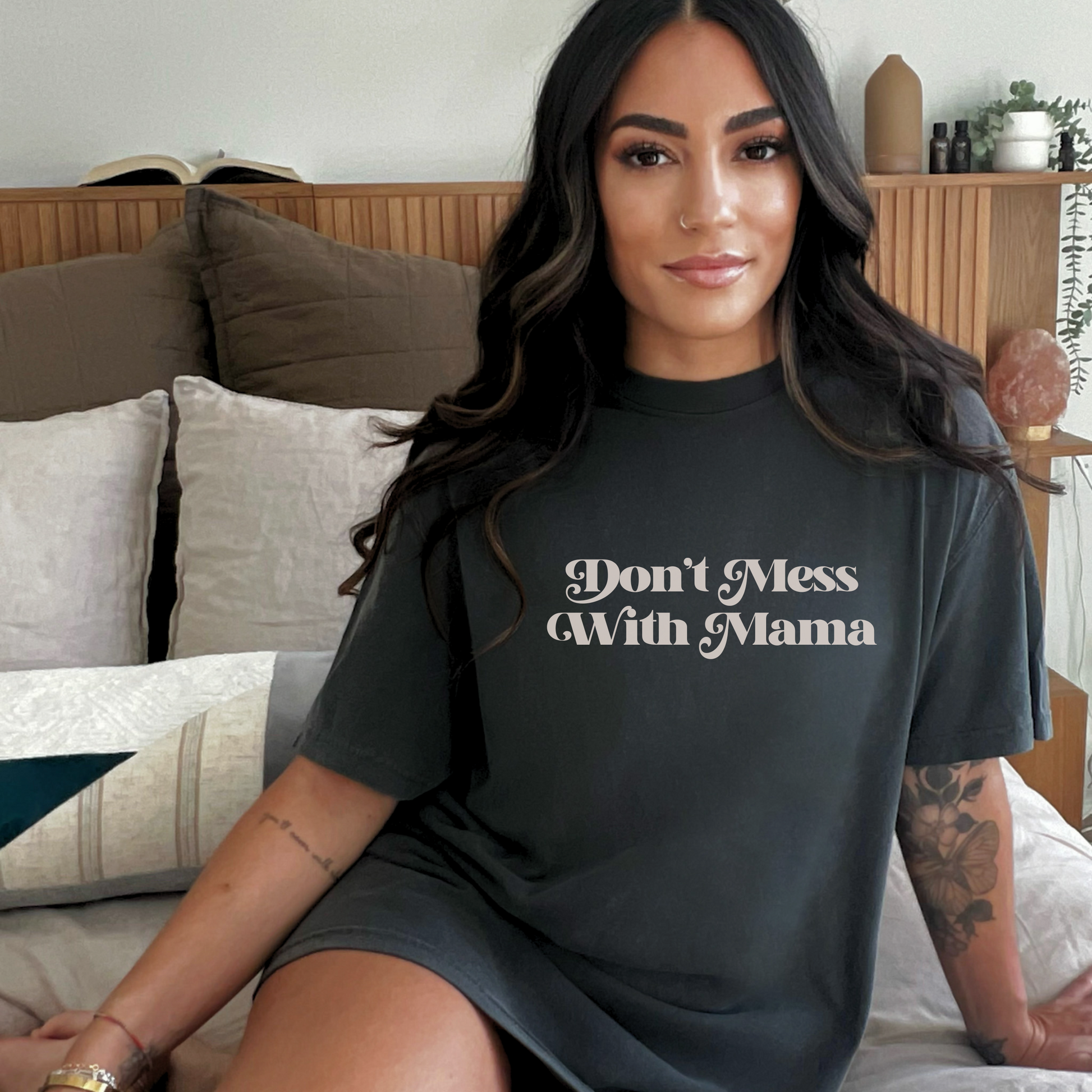 Latina woman wearing a black oversized “Don’t Mess With Mama” T-shirt. Mother’s Day Gift!