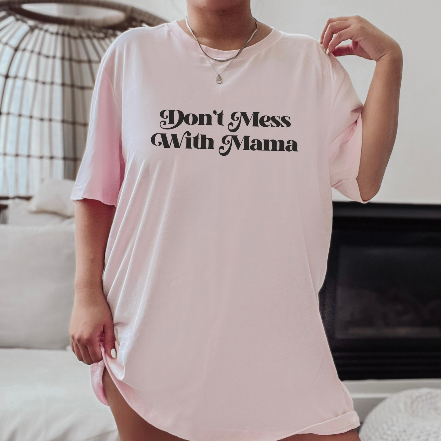 Woman wearing an oversized light pink “Don’t Mess With Mama” T-shirt. Mother’s Day Gift!