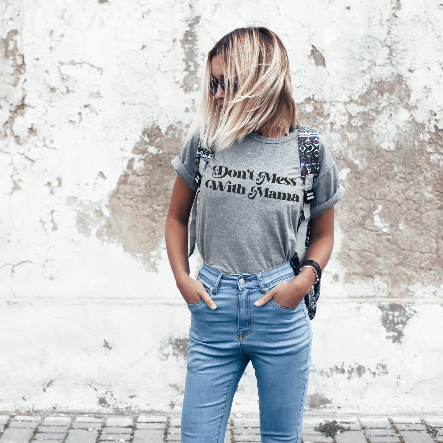 Blonde woman wearing a heather gray “Don’t Mess With Mama” T-shirt. Mother’s Day Gift!