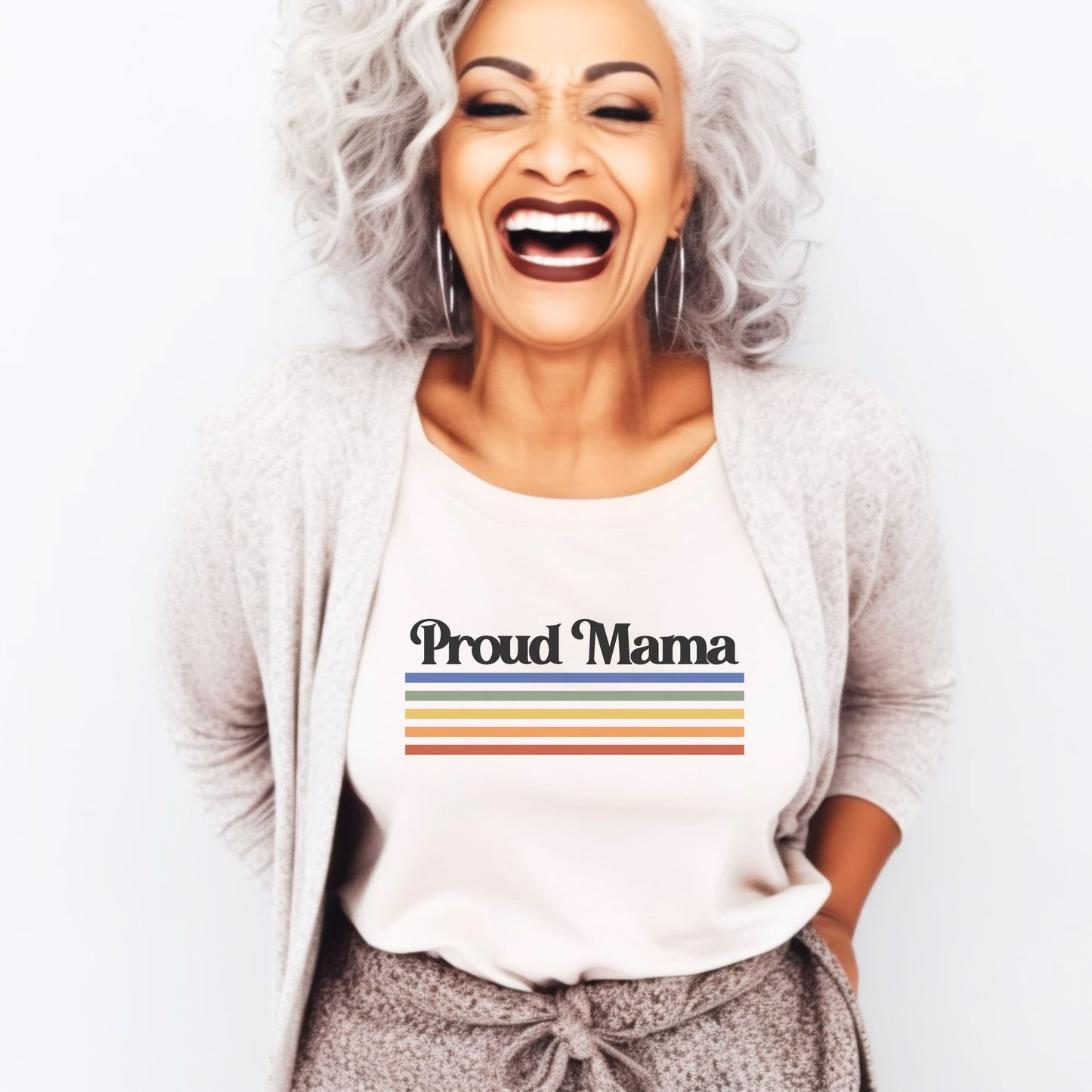 Hispanic woman laughing while wearing a natural color “Proud Mama” rainbow t-shirt.